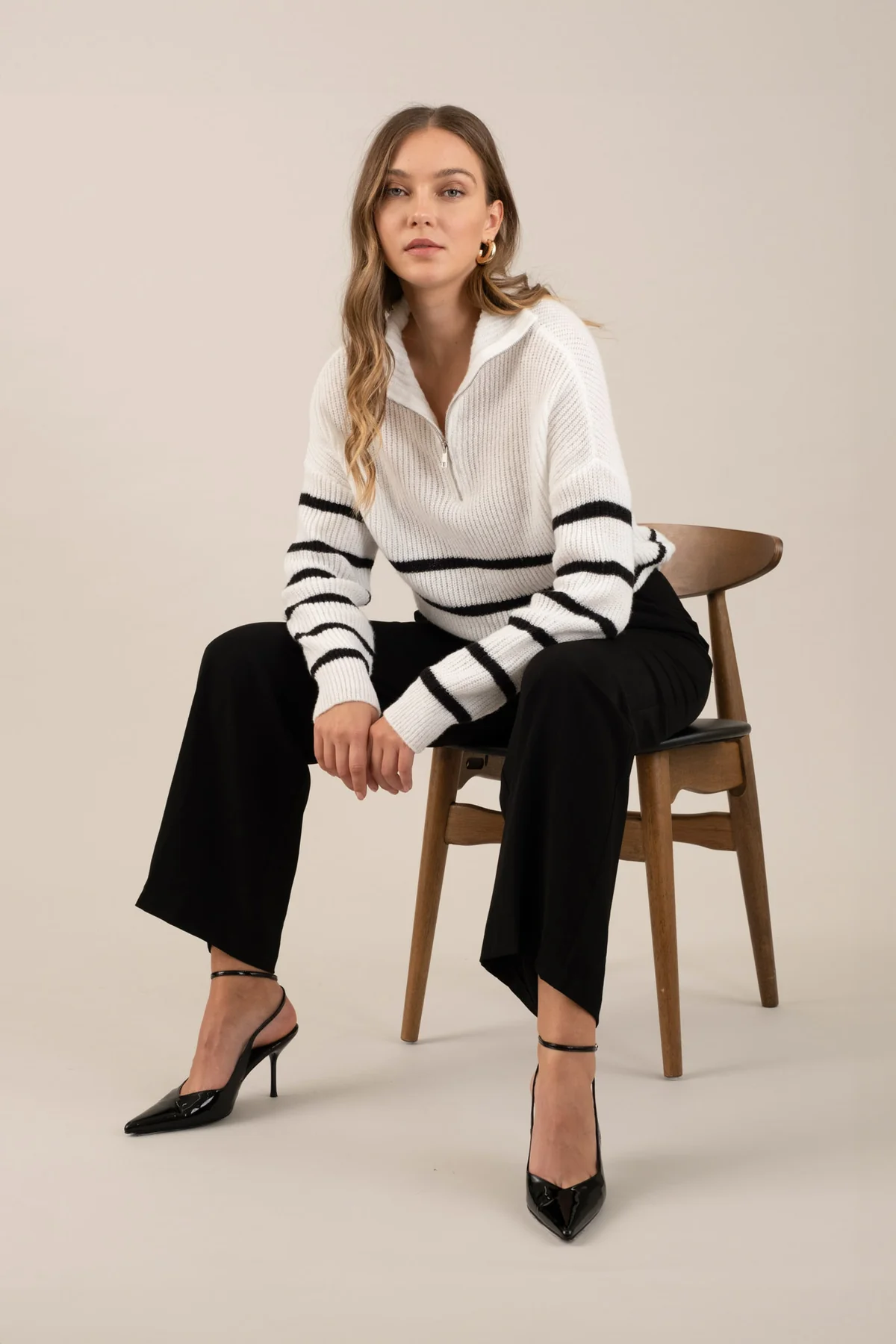 Black pleated wide-leg trousers, seated styling view