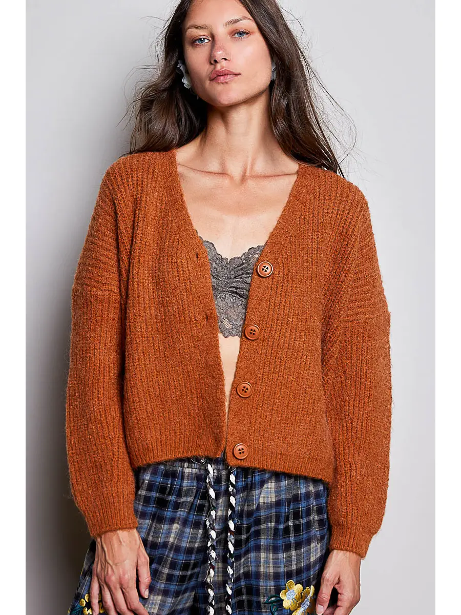 Orange V-neck button-front cardigan on model, front view