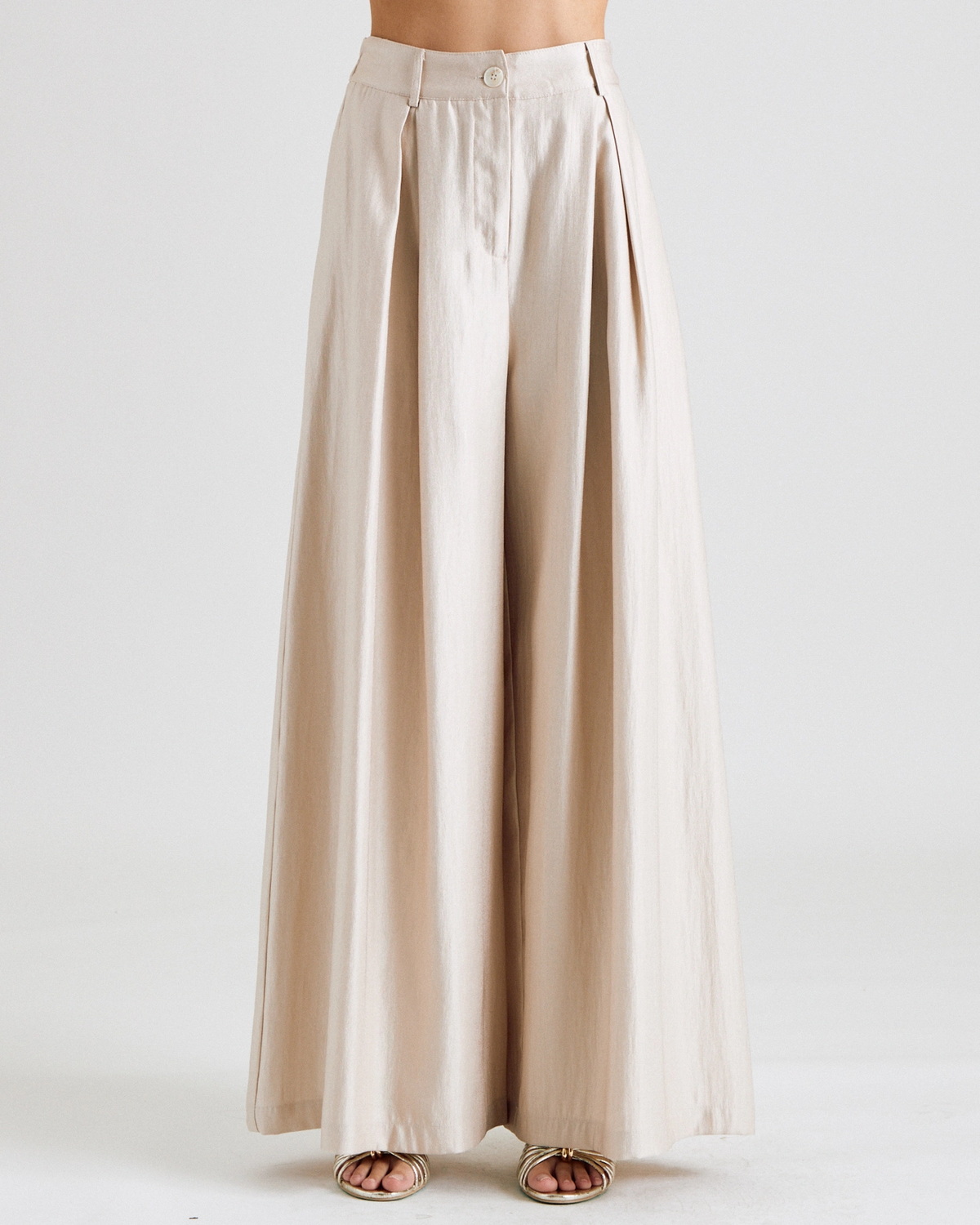 Champagne tailored trousers styled with the matching vest
