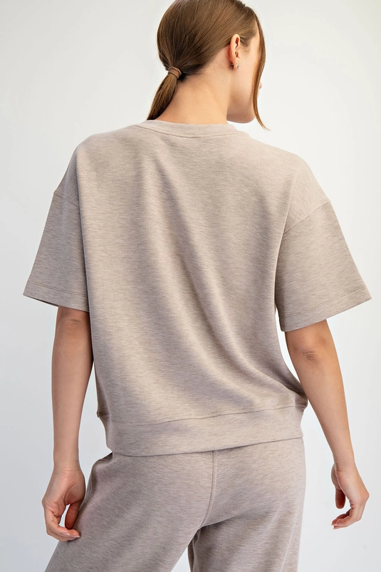 Relaxed short-sleeve top showing dropped shoulders and boxy shape