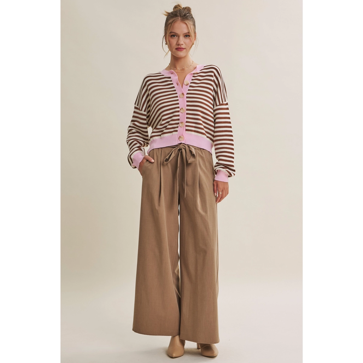 Full outfit view of cropped brown striped cardigan with pink trim