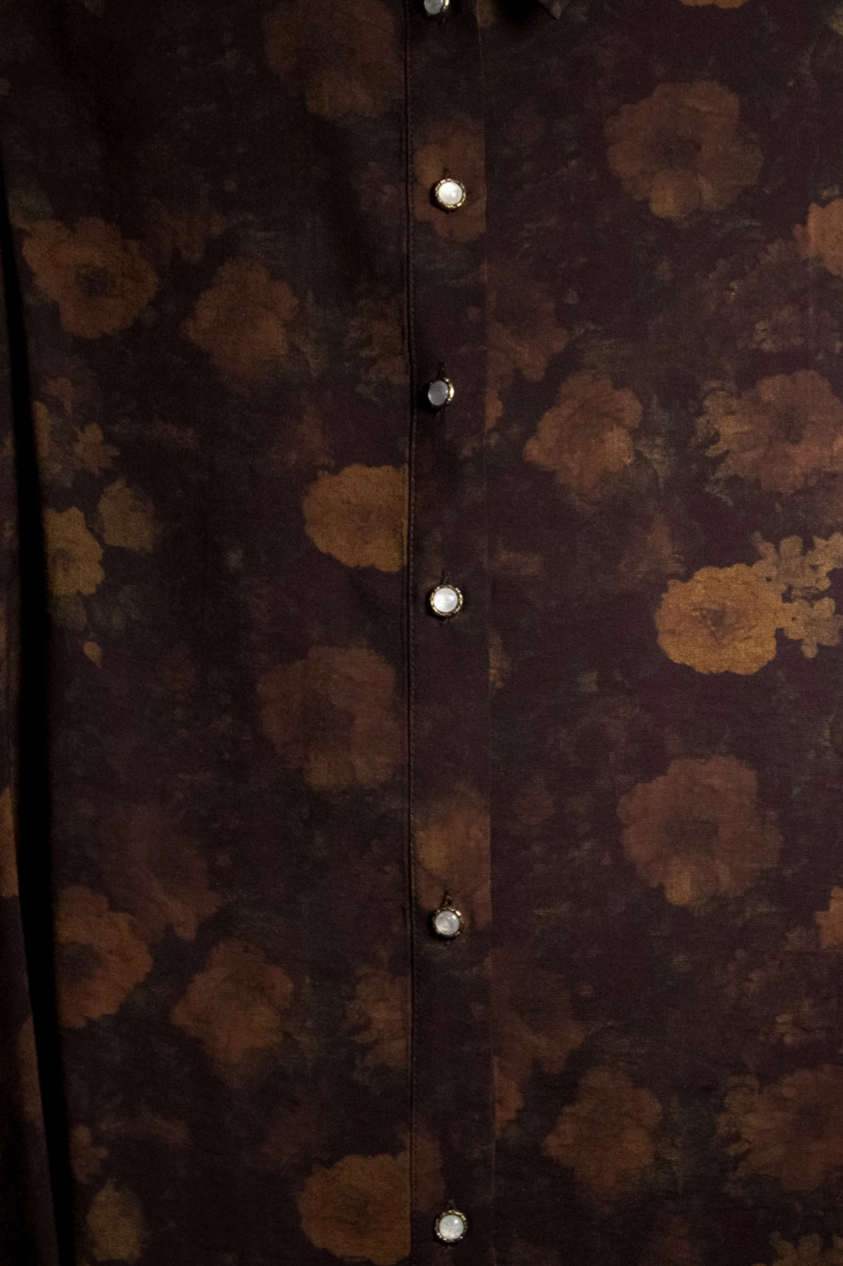 Close-up of burgundy floral print and pearl-look buttons