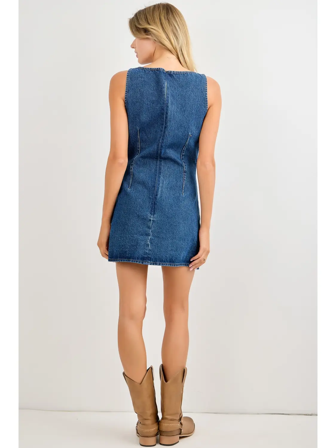 Blue sleeveless denim mini dress on model, back view