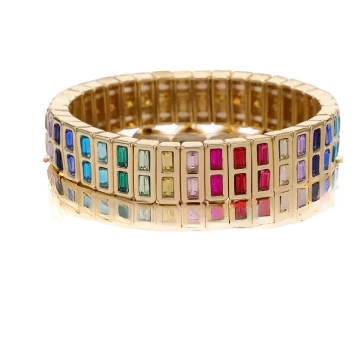 Gold bracelet with colorful gemstones on a white background