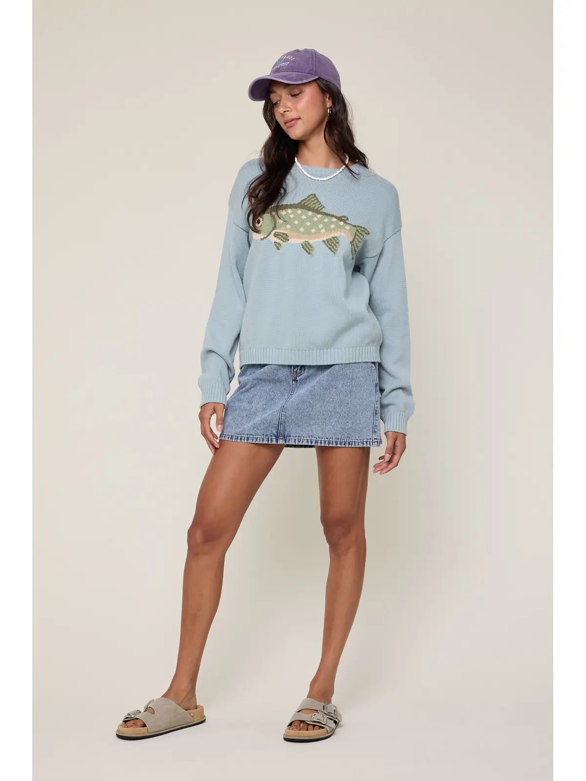 Fish graphic sweater styled with a denim mini skirt
