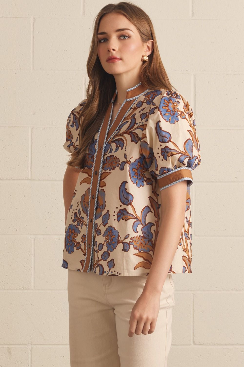 Ivory floral contrast-trim top with a ruffled split neckline and short puff sleeves