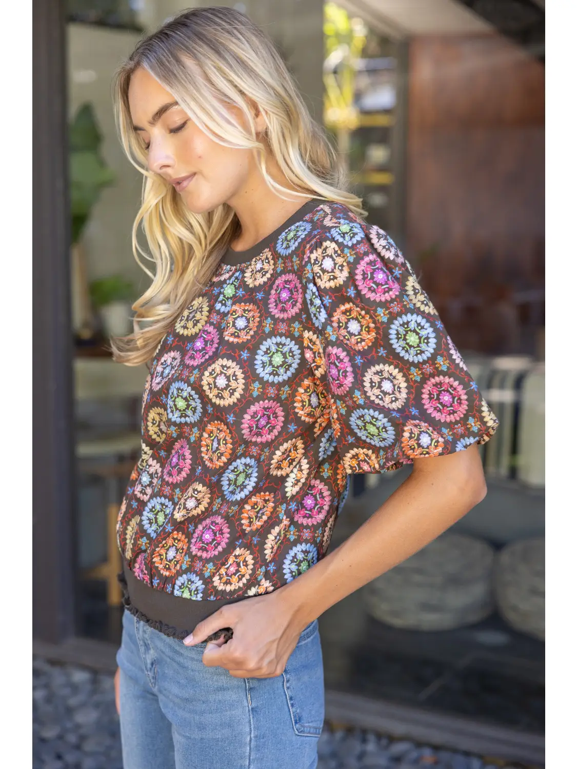 Medallion-print top showing the gathered ruffle hem