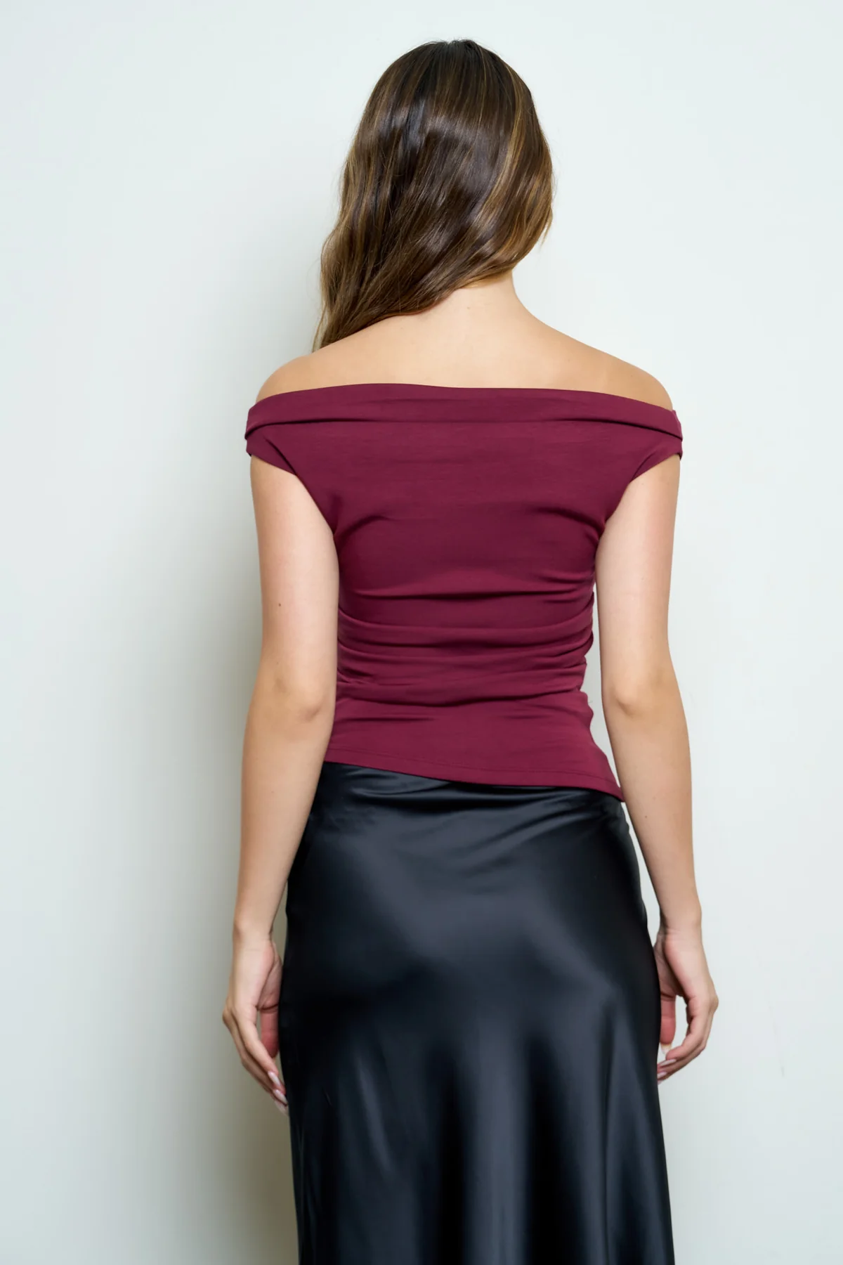 Ruched neckline detail on burgundy off-shoulder top