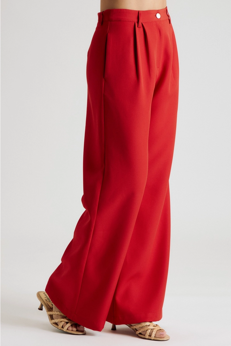 Side view of red pleated wide-leg trousers