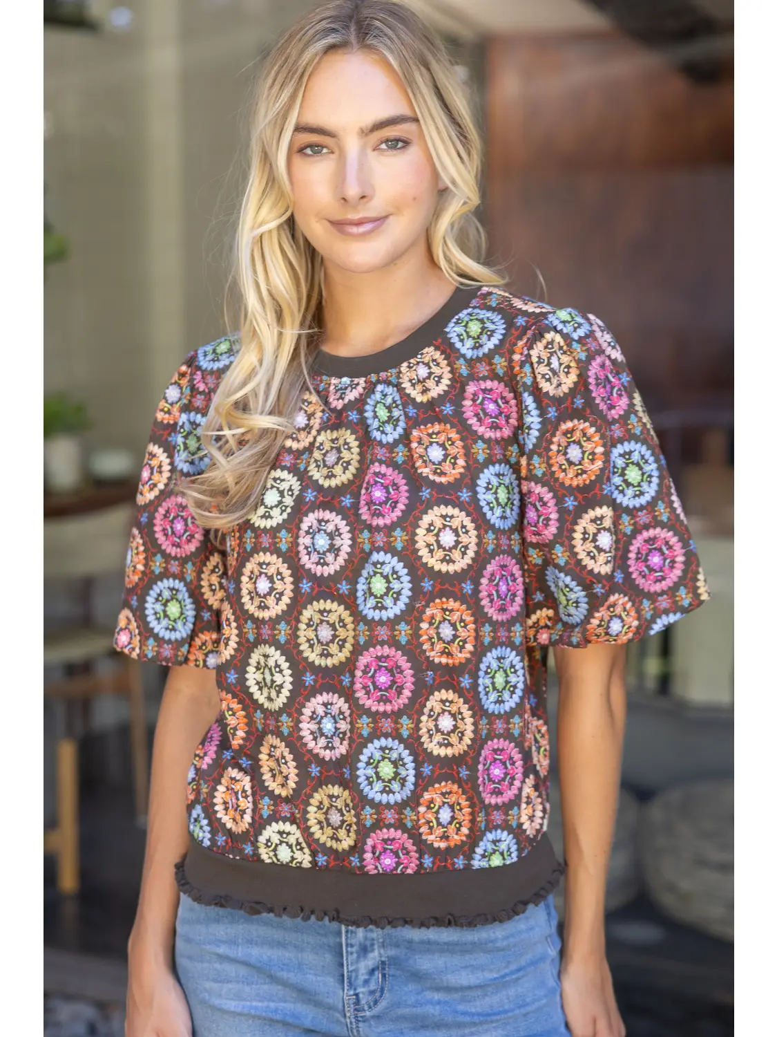 Floral top showing puff sleeves and contrast crew neckline
