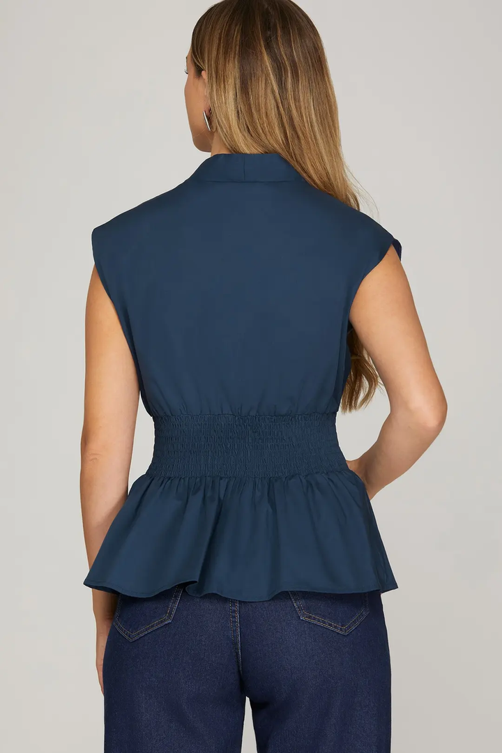 Navy short-sleeve top with front zipper and smocked waist