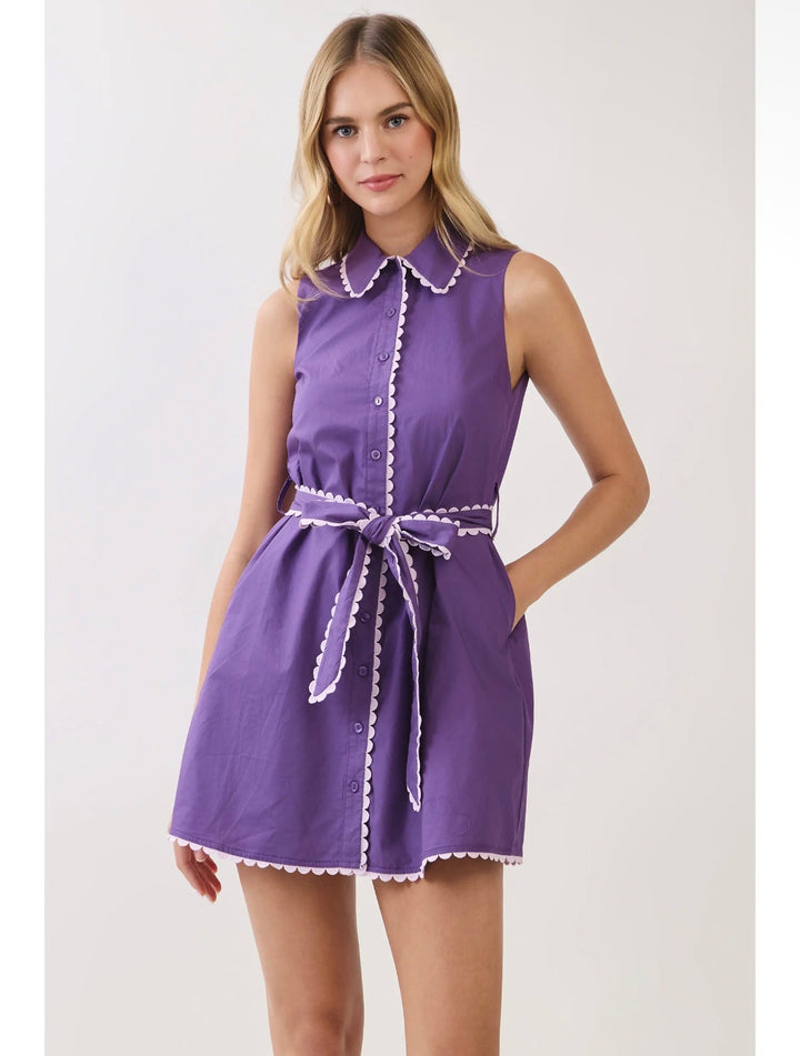 Model wearing purple scallop-trim shirt dress with self-tie belt