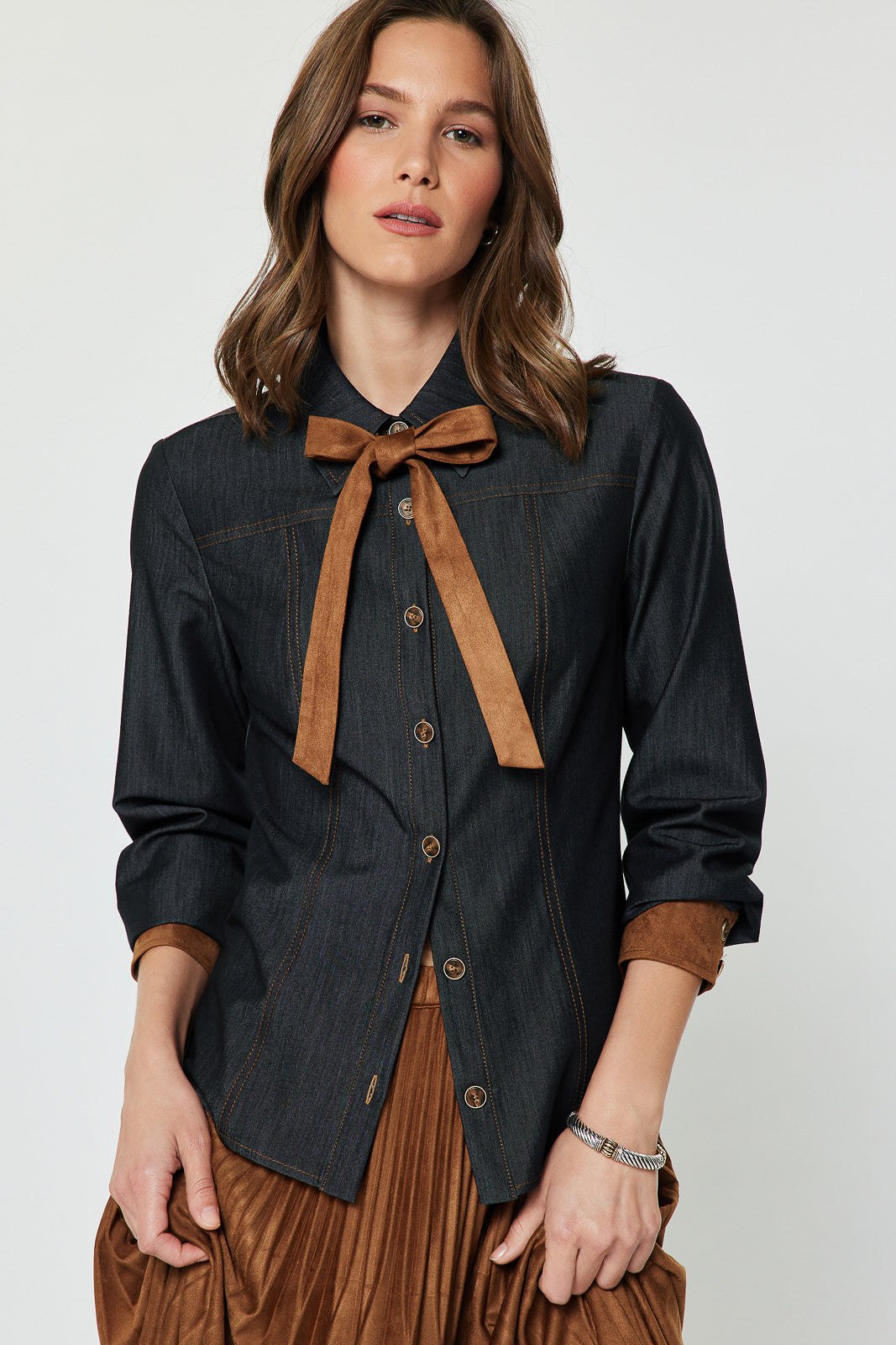 Dark-denim button-front blouse with brown contrast bow and cuffs, front view