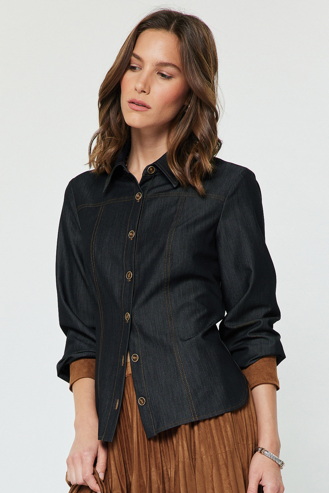 Dark-denim button-front blouse with brown contrast cuffs, angled view