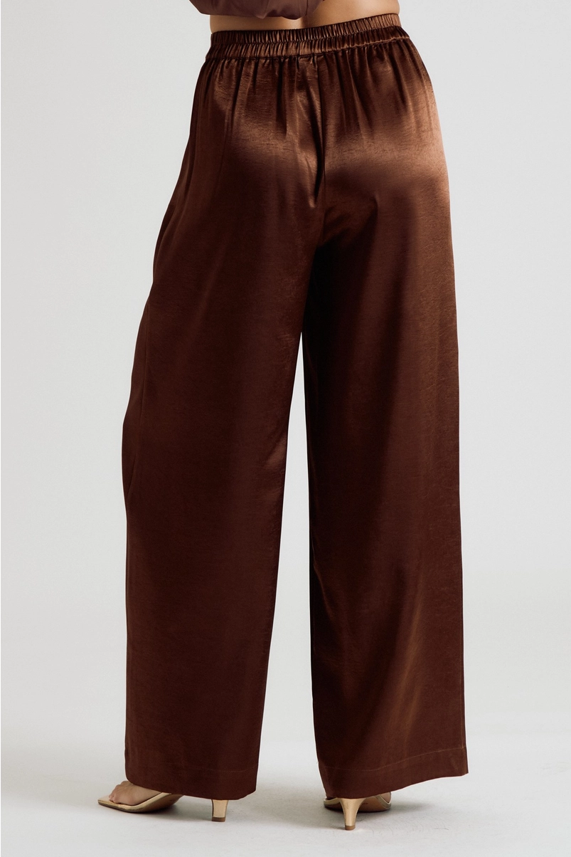 Back view of brown satin trousers with elasticized waist