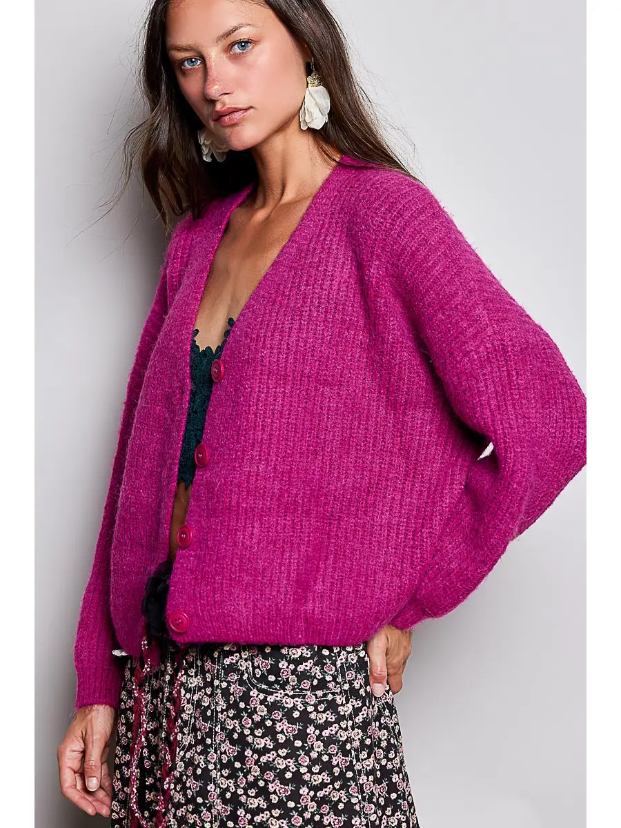 Pink V-neck cardigan showing the relaxed side fit