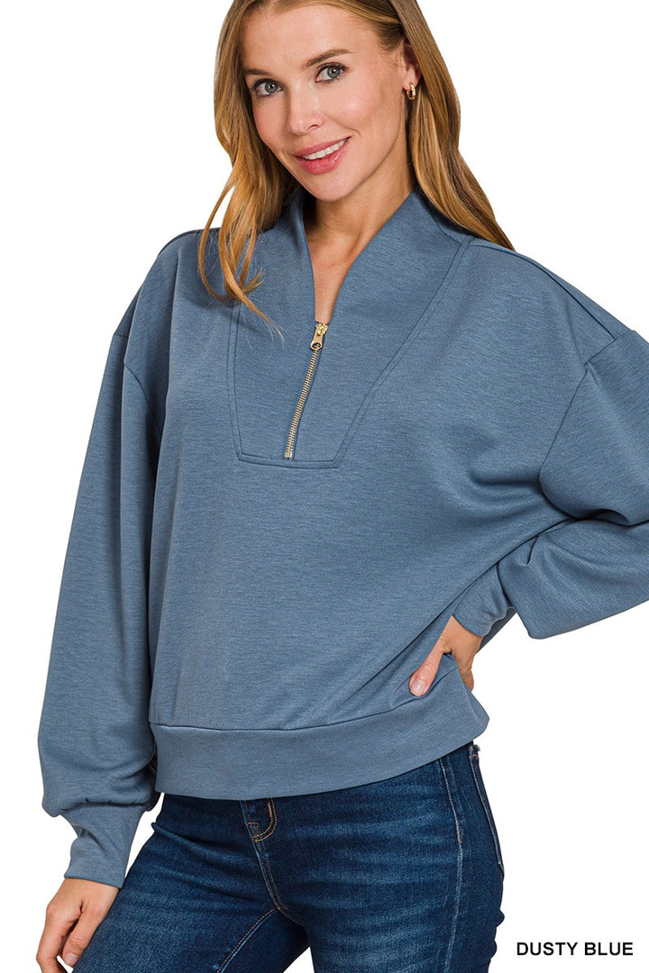 Model wearing dusty-blue scuba half-zip pullover
