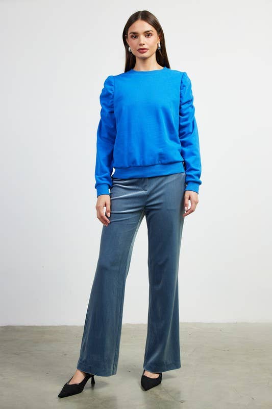 Blue ruched-sleeve knit top styled with denim