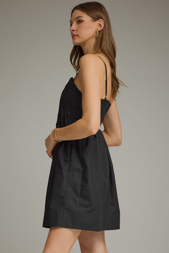 Black pleated sleeveless mini dress with a square neckline and gathered A-line skirt