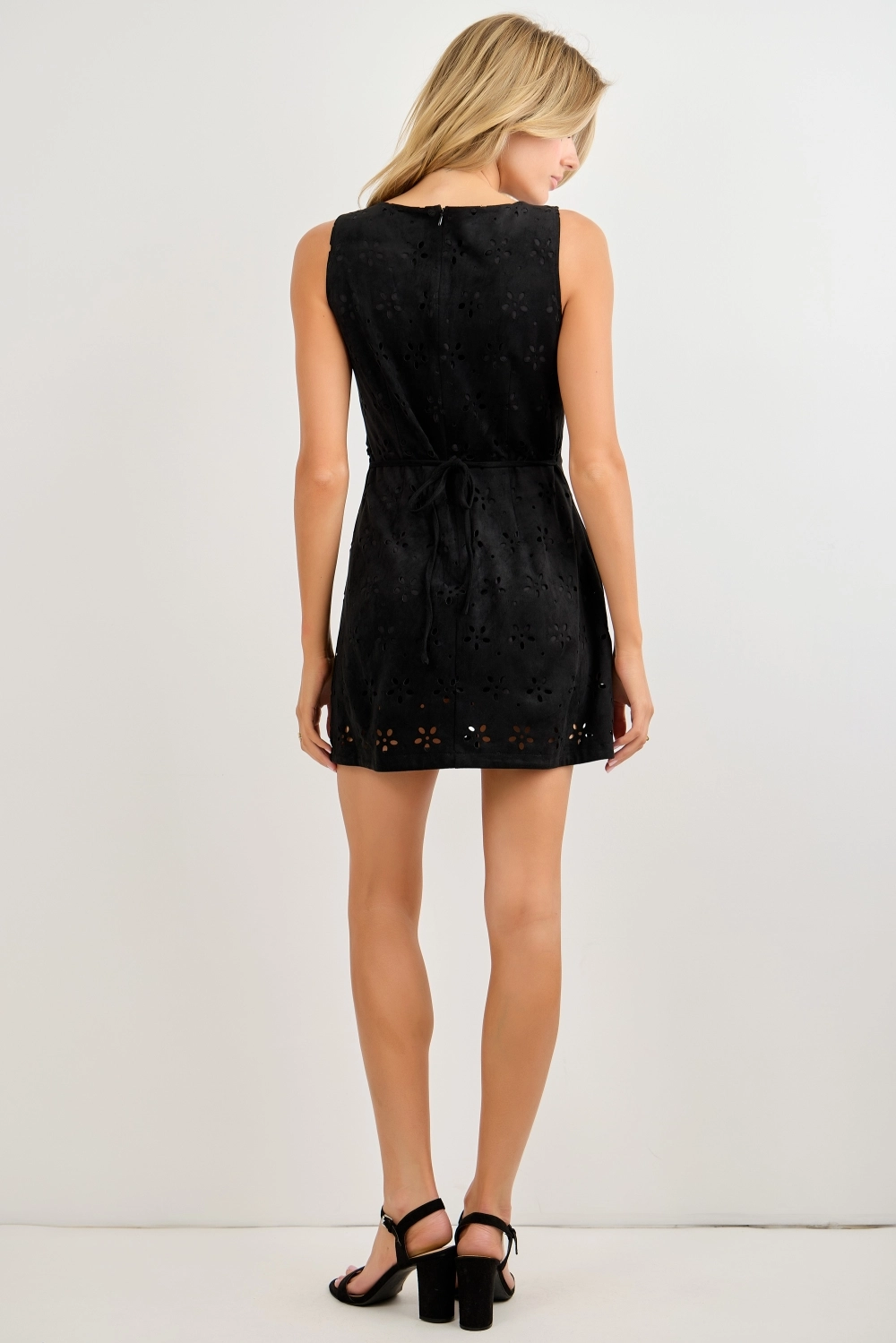 Black sleeveless laser-cut romper showing the back fit