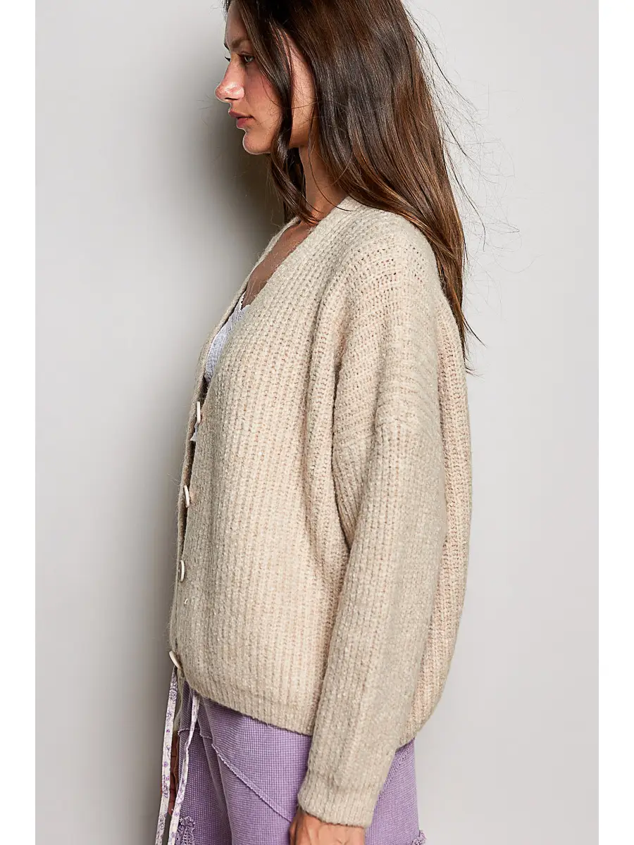 Tan V-neck cardigan on model, side view