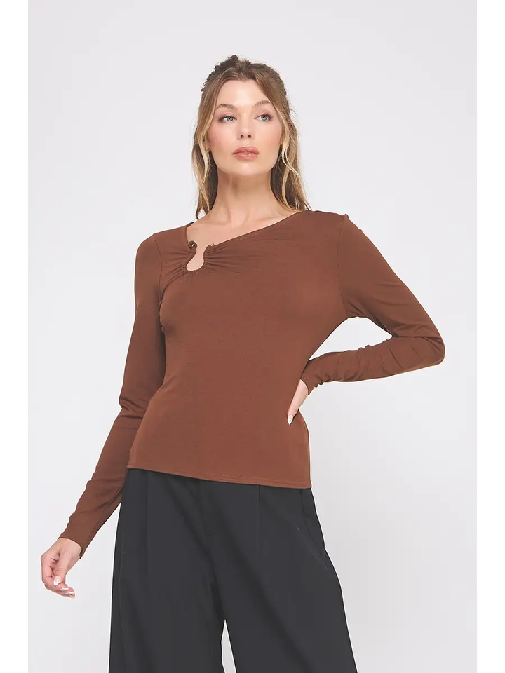 Model wearing brown asymmetric-neck long-sleeve top