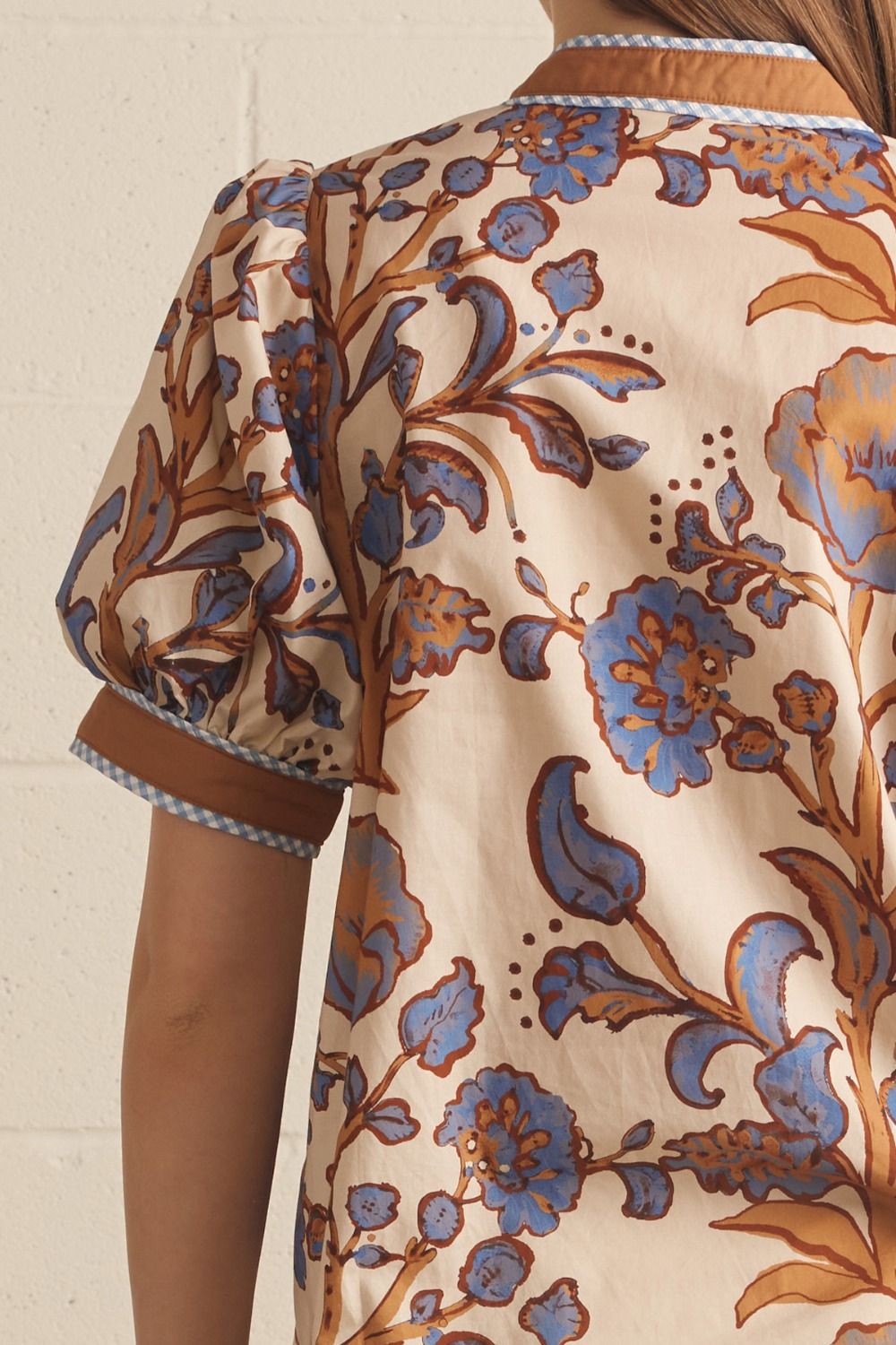 Ivory floral contrast-trim top with a ruffled split neckline and short puff sleeves