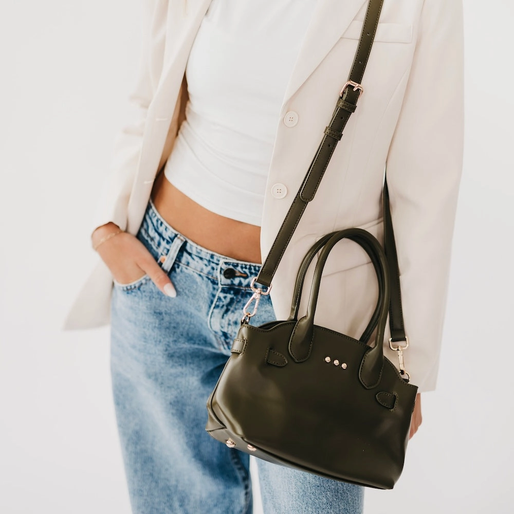 Veronica small tote in green worn with adjustable crossbody strap