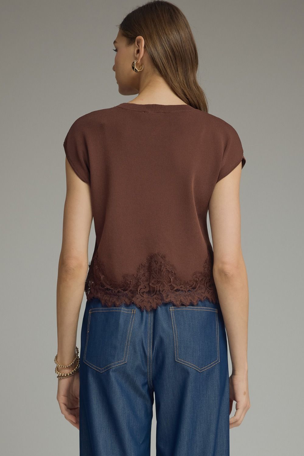 Back view of brown knit top with cap sleeves and tonal scalloped floral-lace hem