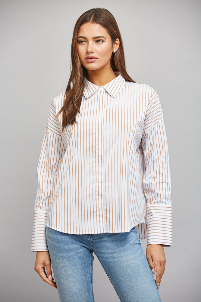 Model wearing tan-and-white striped button-down shirt
