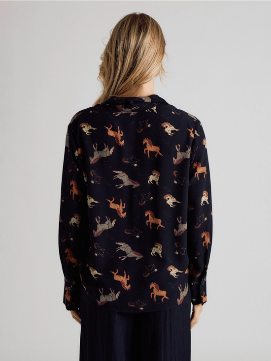 Back view of black horse-print button-up blouse