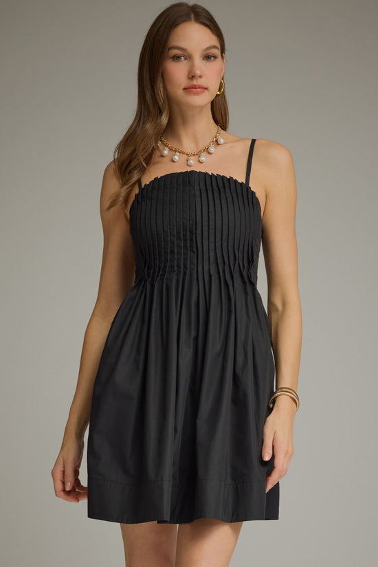 Black pleated sleeveless mini dress with a square neckline and gathered A-line skirt
