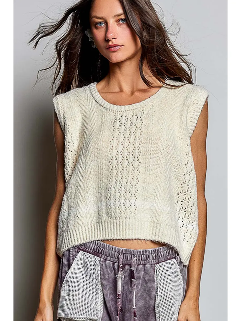 Cream pointelle cable-knit sweater vest on model, front view