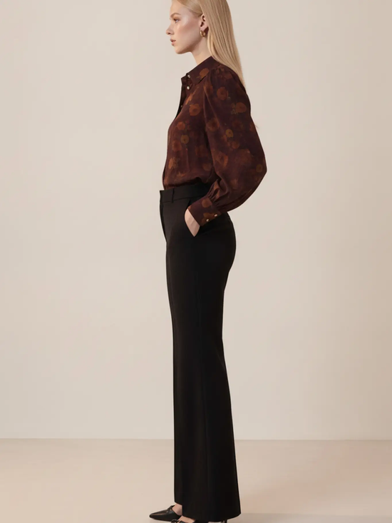 Burgundy floral blouse side view styled with black trousers