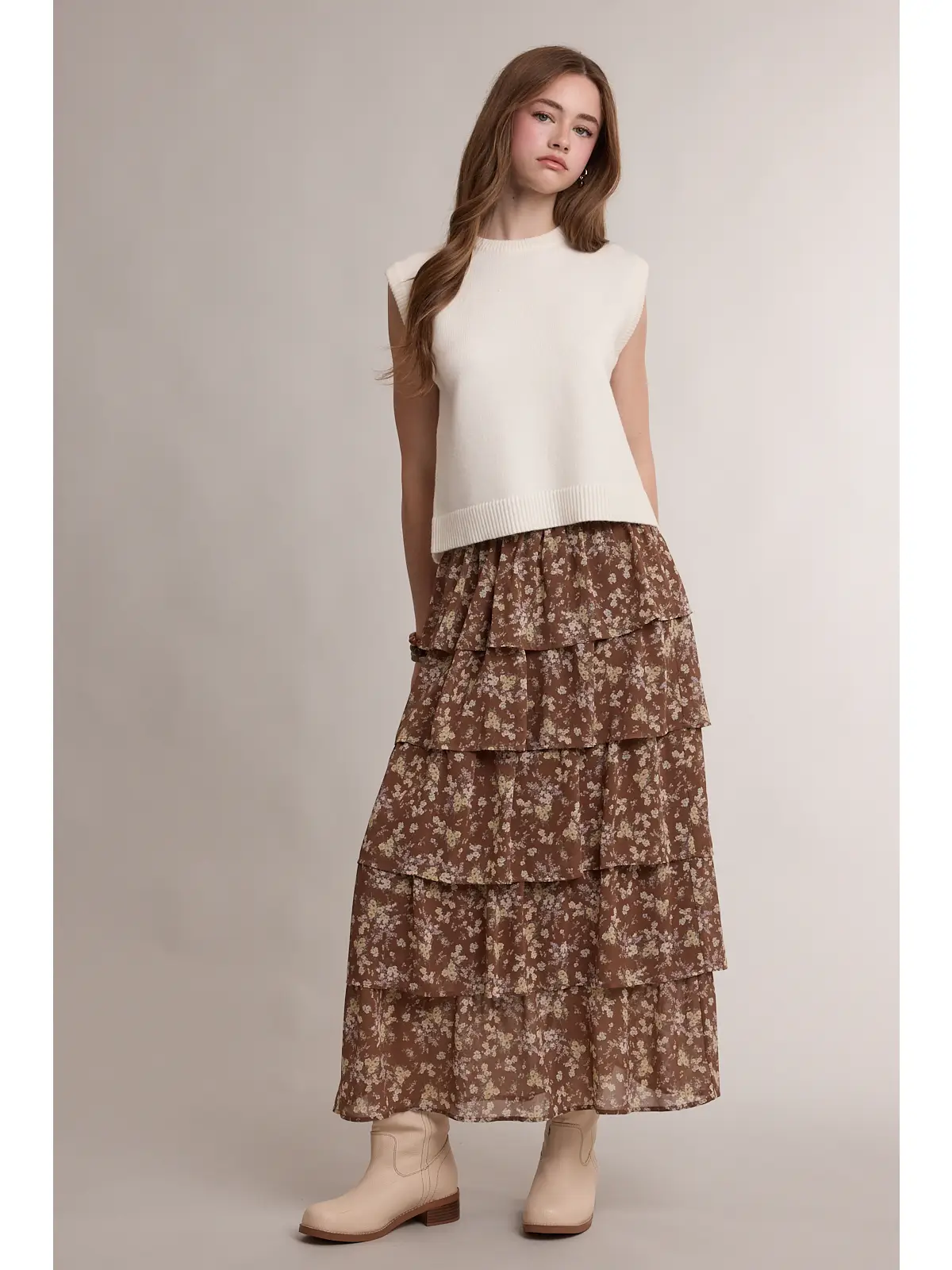 Ivory sweater vest styled with a brown floral maxi skirt