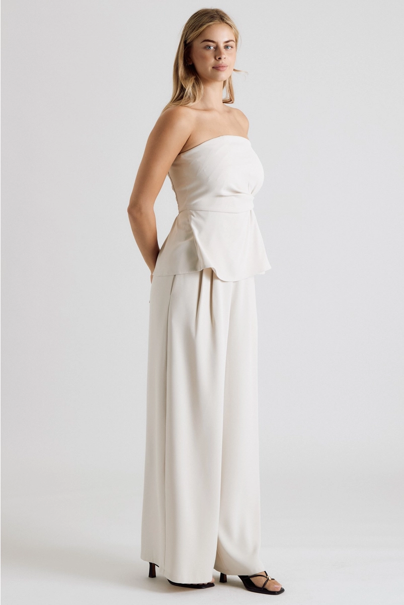 Cream strapless top styled with matching wide-leg trousers
