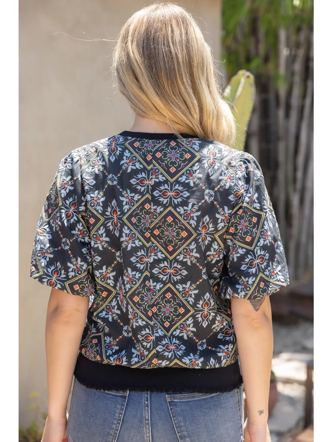 Black ornamental tile-print top styled for a boutique look