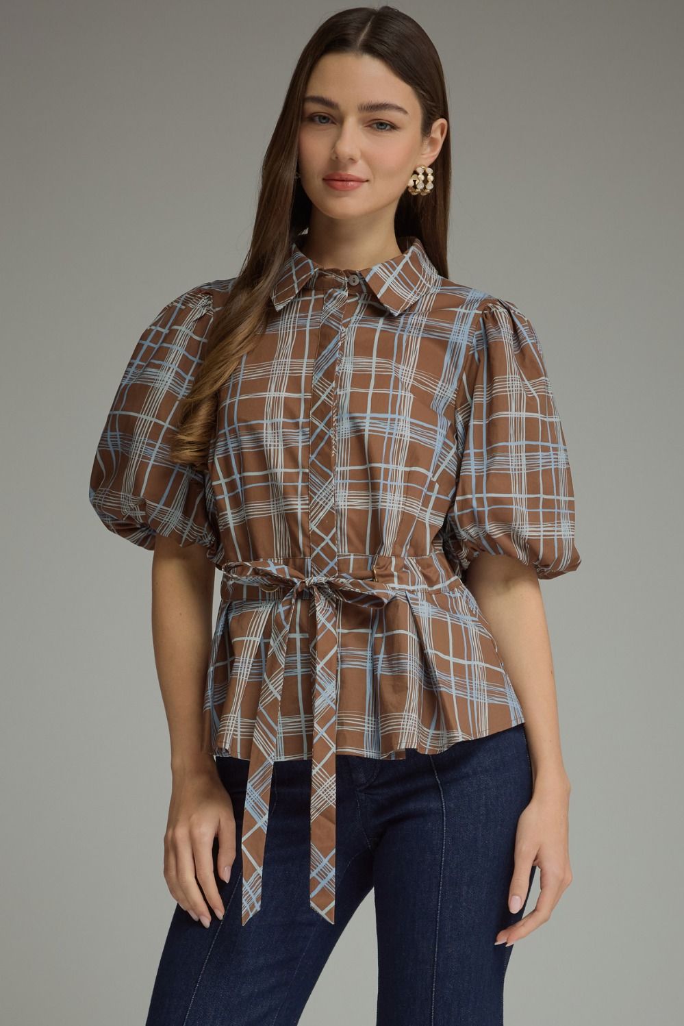 Front view of brown plaid puff-sleeve belted top