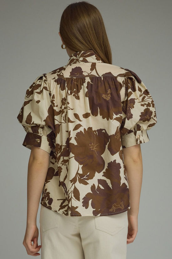 Brown floral puff-sleeve top with a ruffle-trim mock neckline and button-front detail