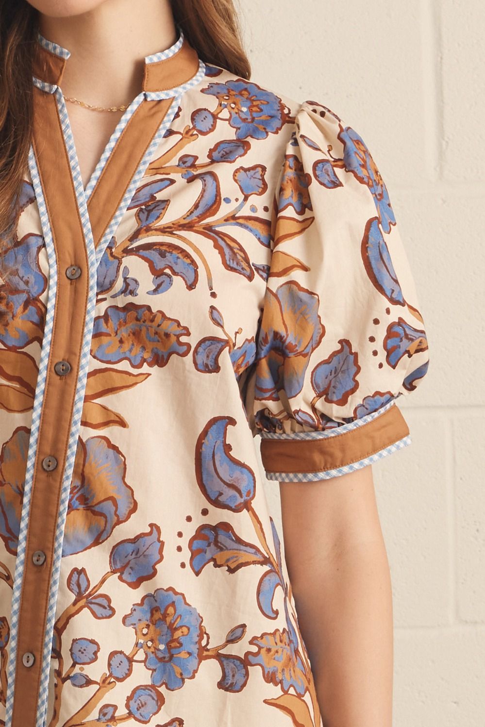 Ivory floral contrast-trim top with a ruffled split neckline and short puff sleeves