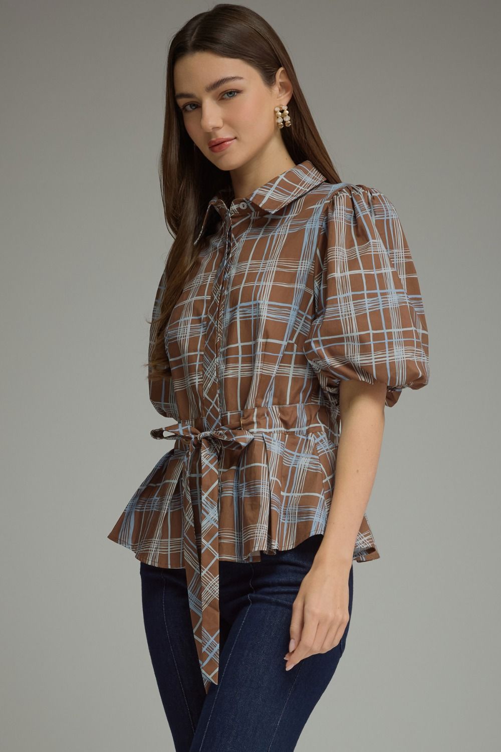 Angled view of brown plaid belted top