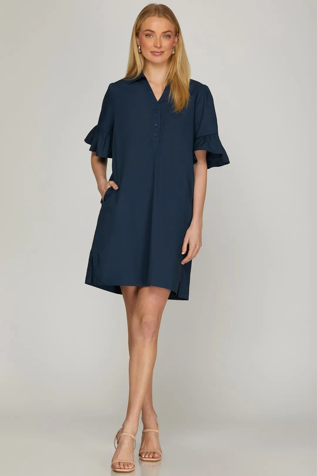 Model wearing navy ruffle bell sleeve mini dress, full-length view