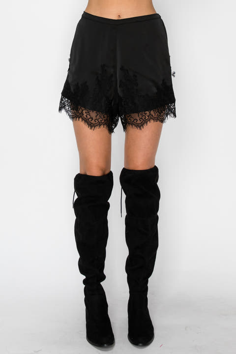 Model wearing black lace-detail boxer shorts