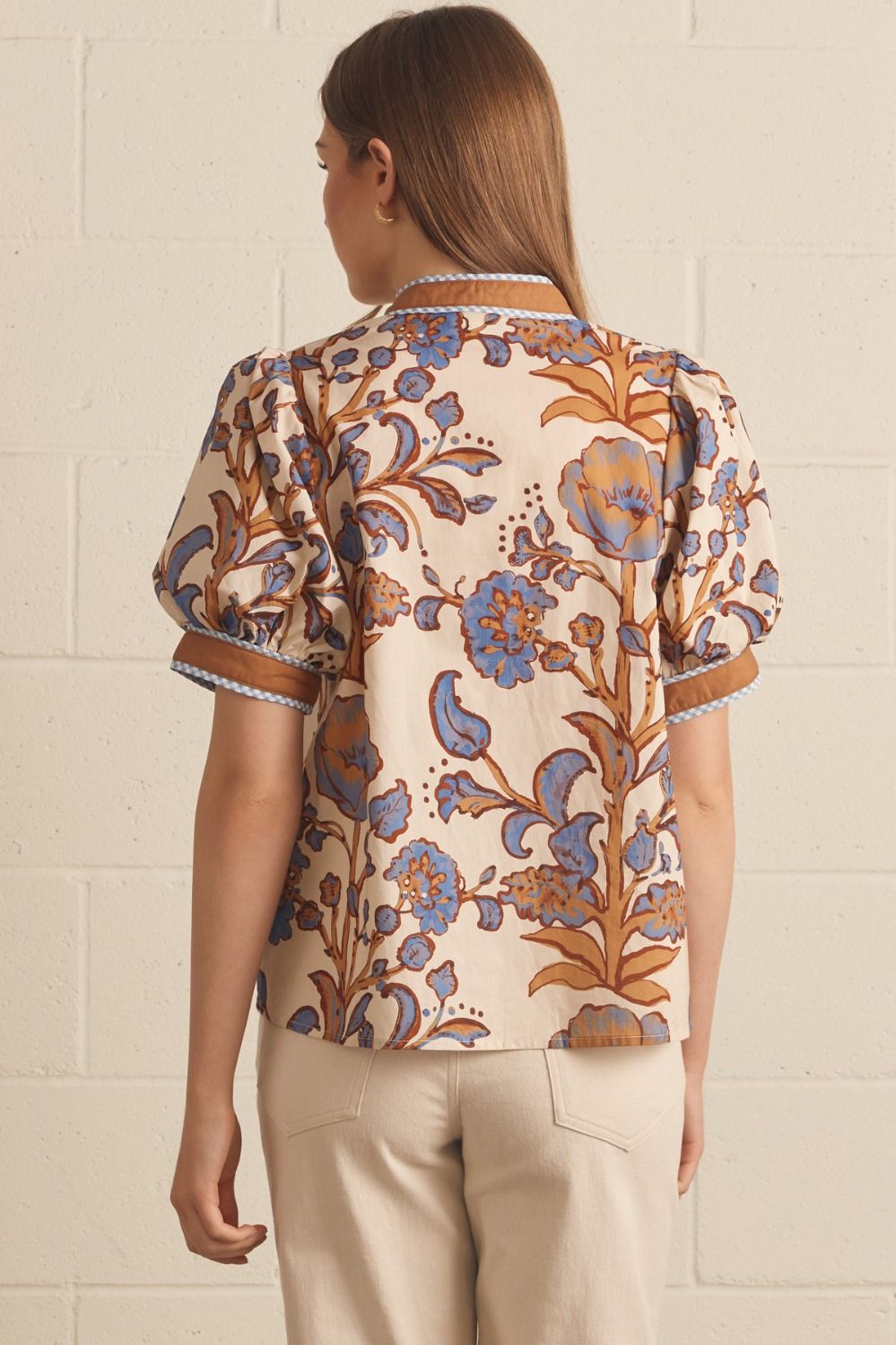 Ivory floral contrast-trim top with a ruffled split neckline and short puff sleeves