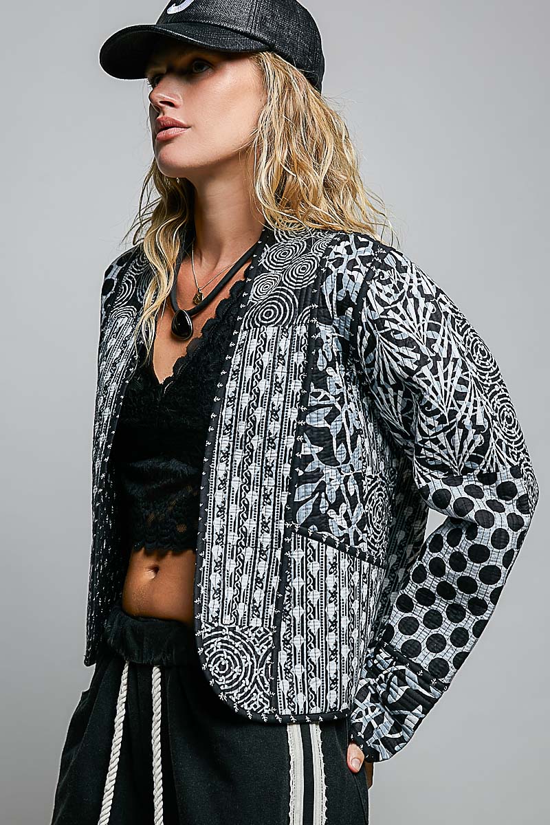Patchwork quilted kimono jacket showing mixed black and ivory motifs
