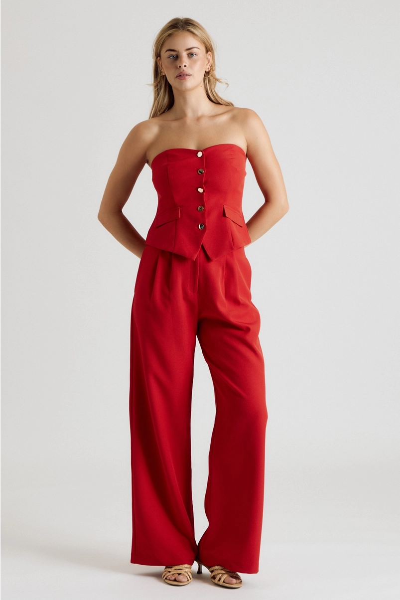 Red strapless button-front vest top styled with matching trousers