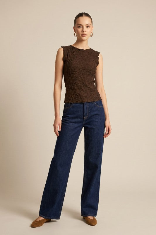 Model wearing brown textured sleeveless top