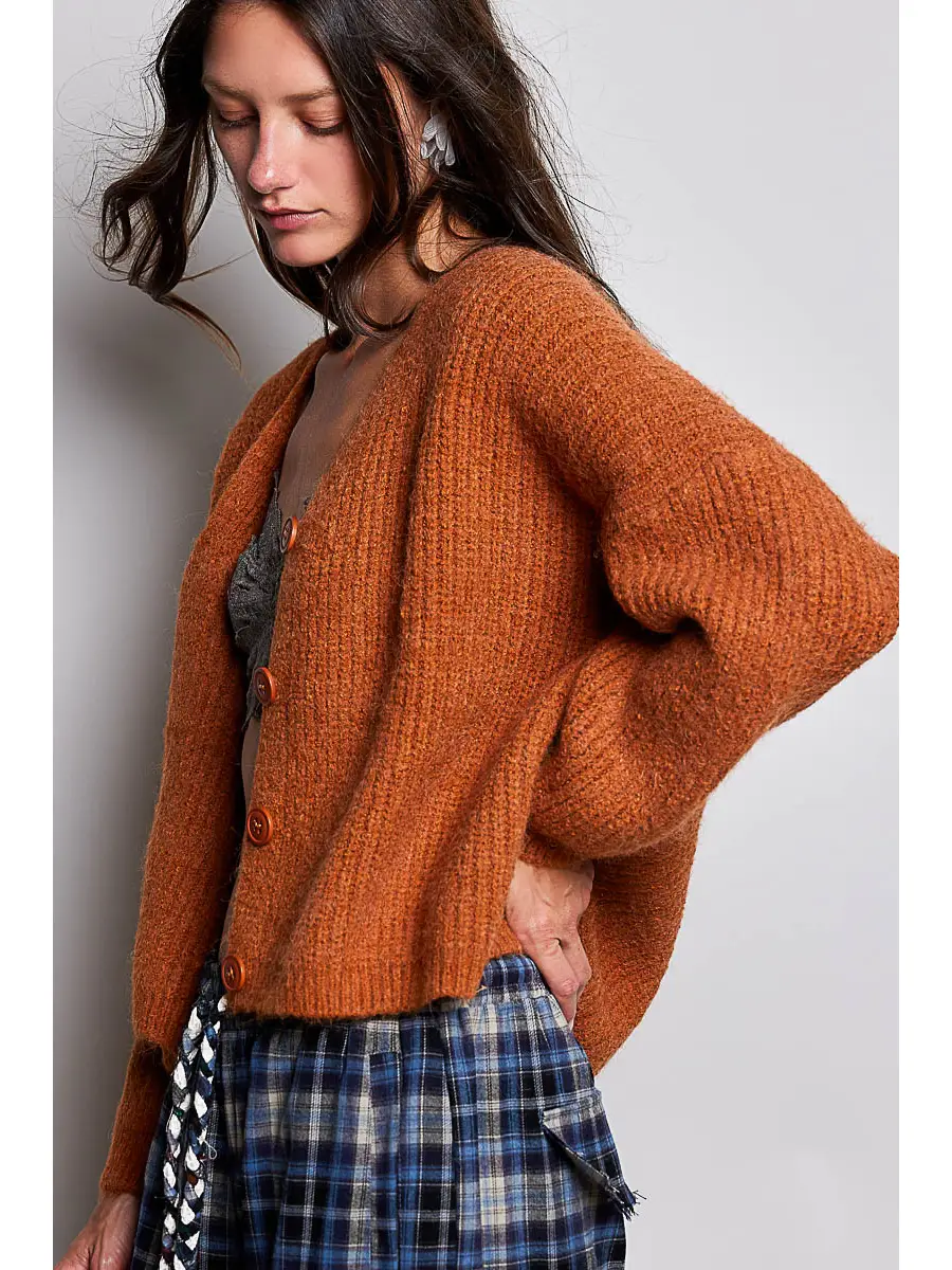 Orange V-neck cardigan showing the relaxed side fit