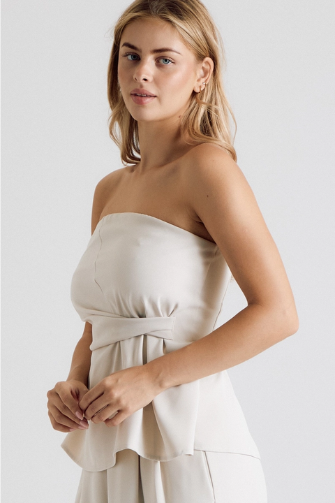 Close-up of cream strapless twist-waist top