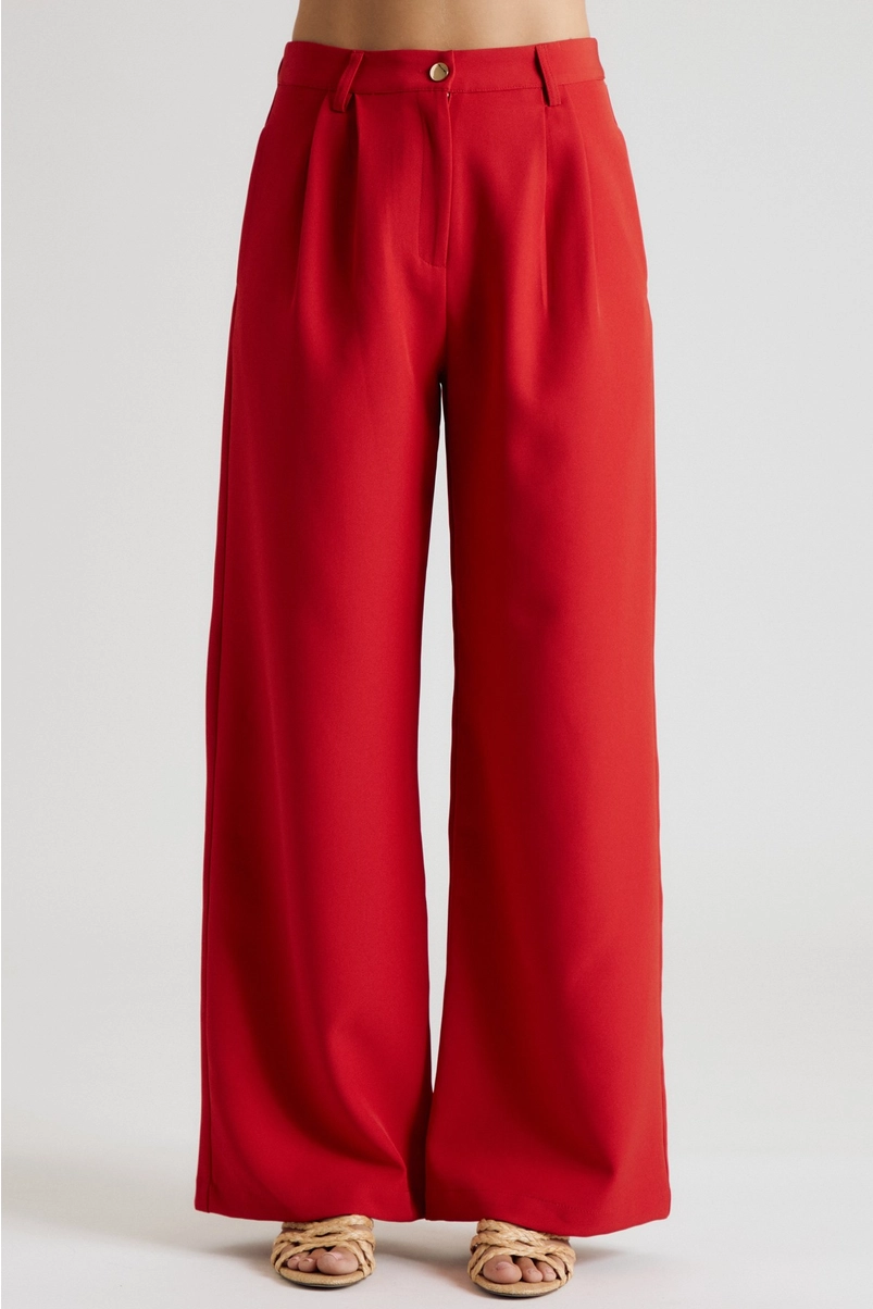 Front view of red high-rise pleated wide-leg trousers